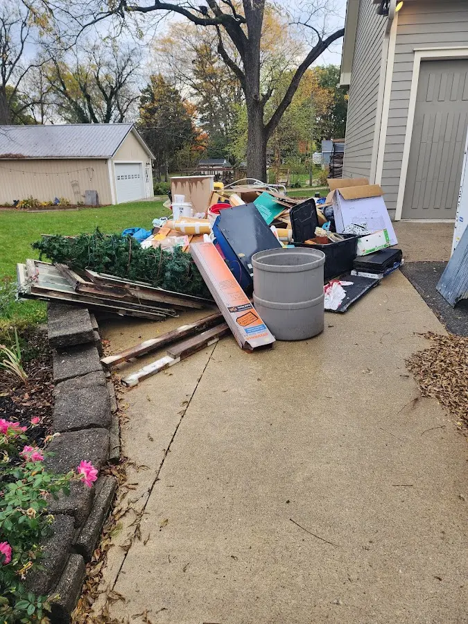 Dumpster being loaded with debris for Estate Cleanout Dumpster Rental in Dakota Dunes